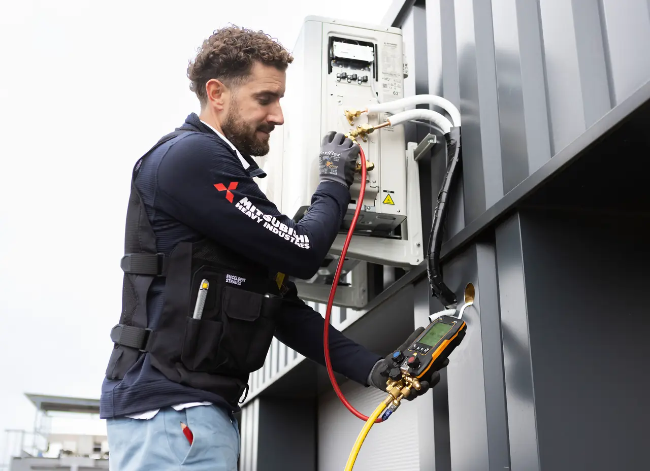 Rein reads the gauges at the newly installed outdoor unit.